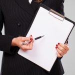 Pen on a blank paper in businesswoman hands with manicure