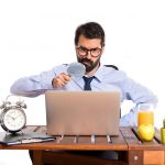 Businessman in his office with magnifying glass