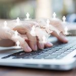 Closeup of business woman hand typing on laptop keyboard